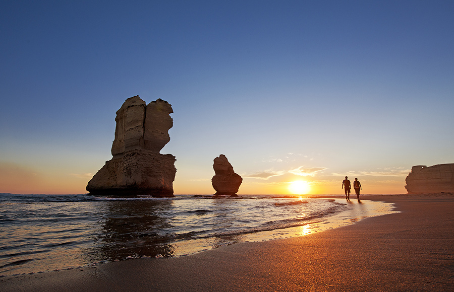 Couple hike past 12 Apostles on Australia Travel